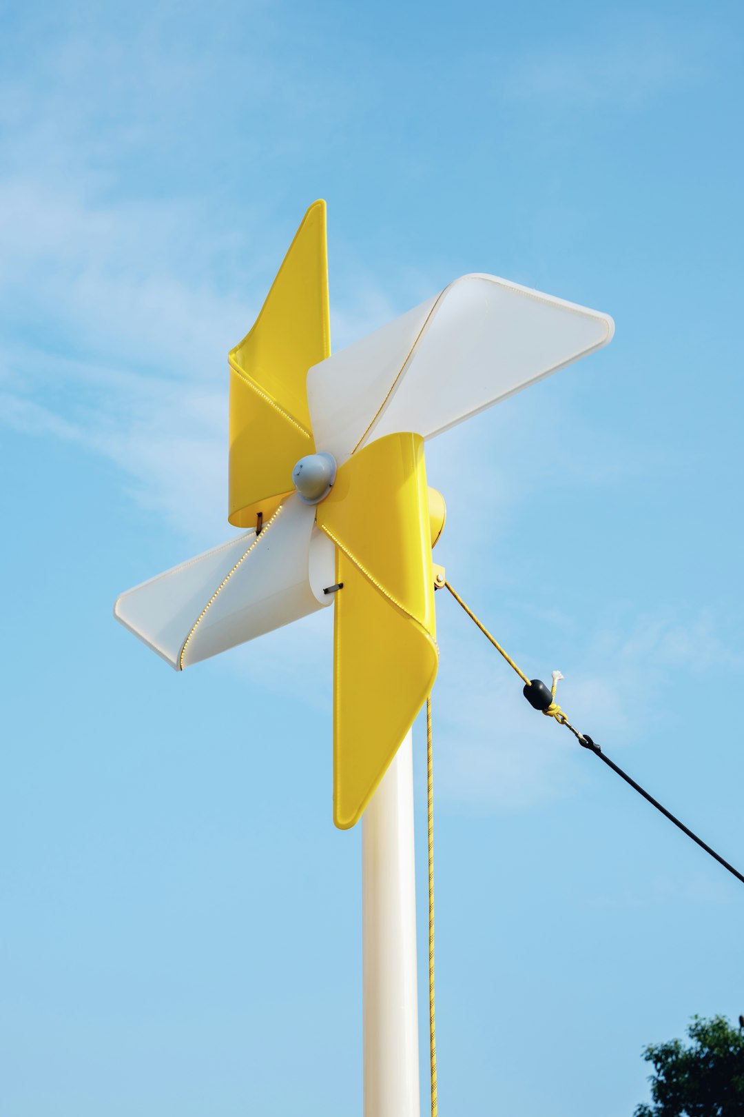 yellow-and-white-pinwheel-against-a-blue-sky-qwgqihzj7z0